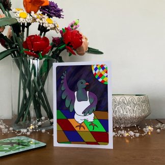 Disco-dancing kererū greeting card on a wooden sideboard.
